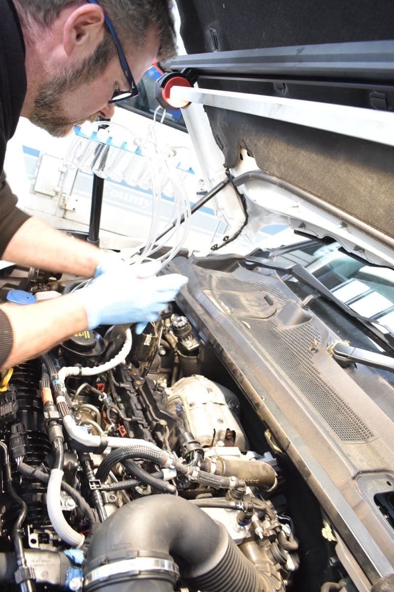 Vehicle on hoist for servicing